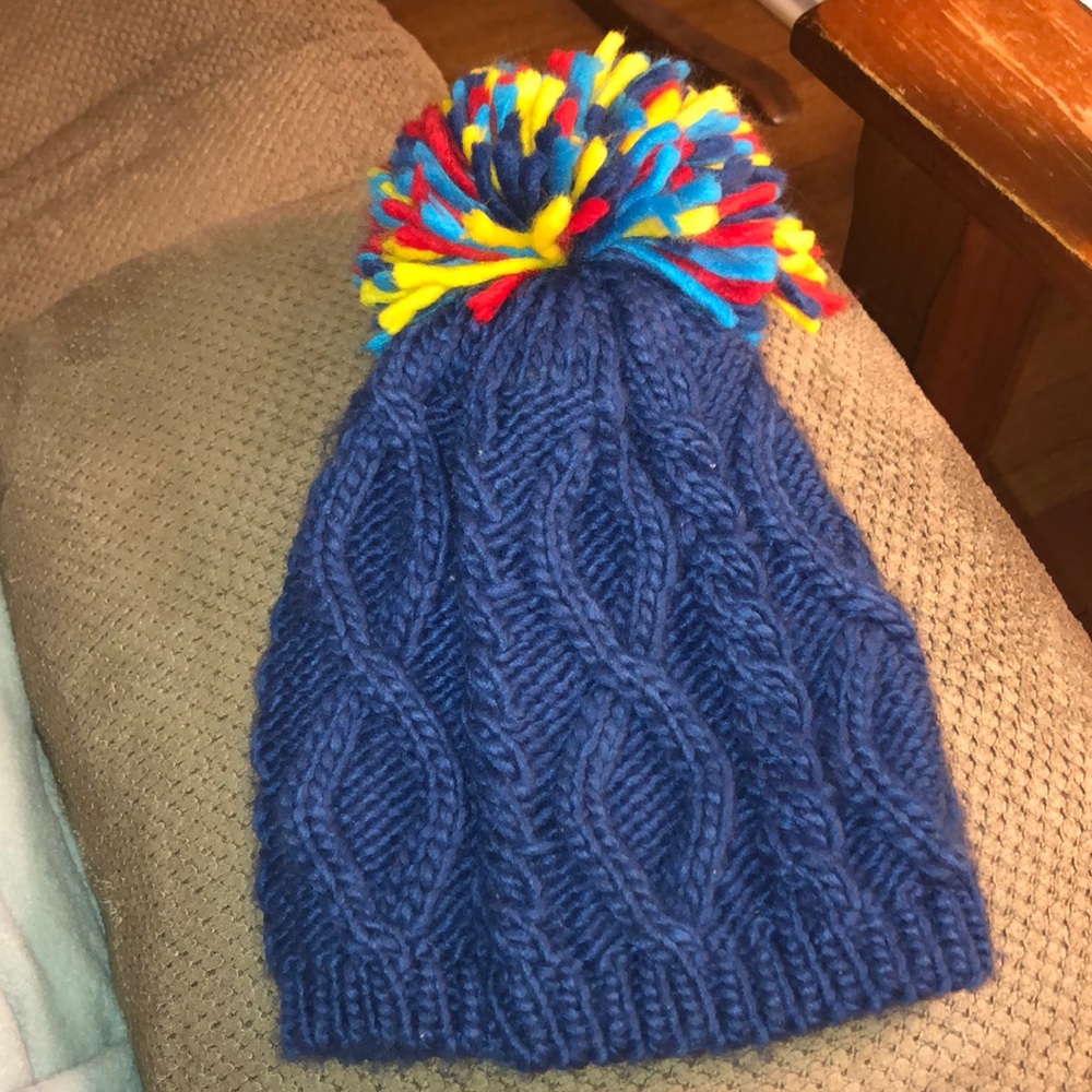 Blue beanie with rainbow pom